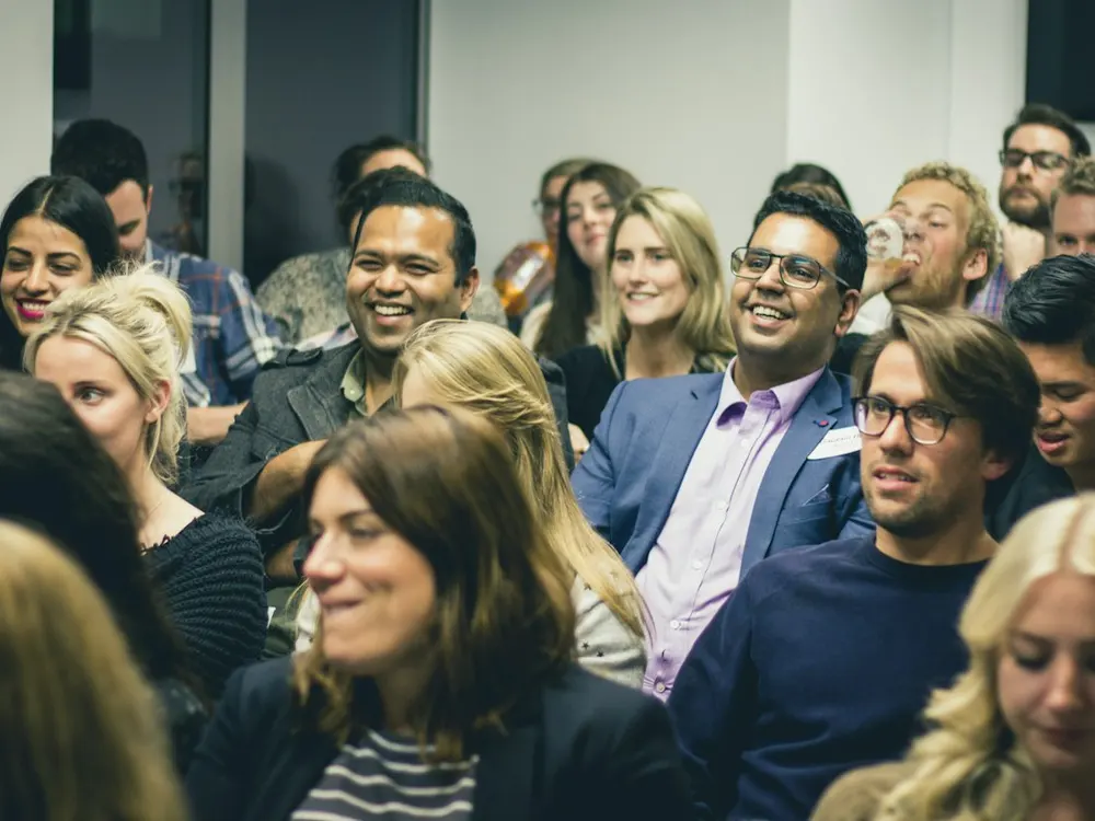A smiling conference audience