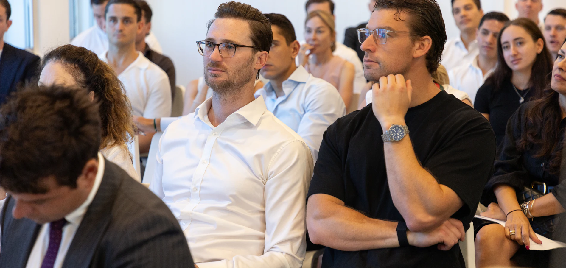 Professionals listening closely during a training session