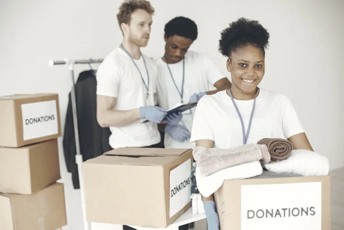 A team of volunteers sorting donations in a bright room